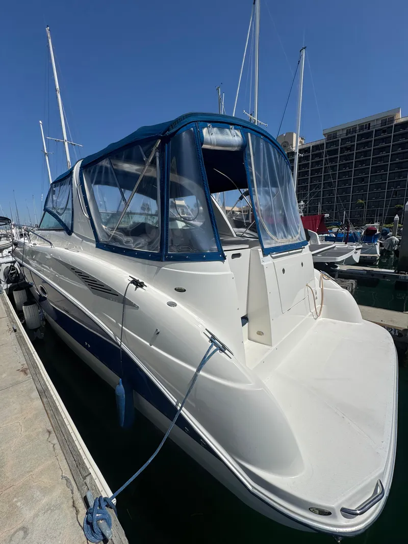 Slide: The Image of 2006 Bayliner 325 boat docked at a marina under clear blue skies. - 4