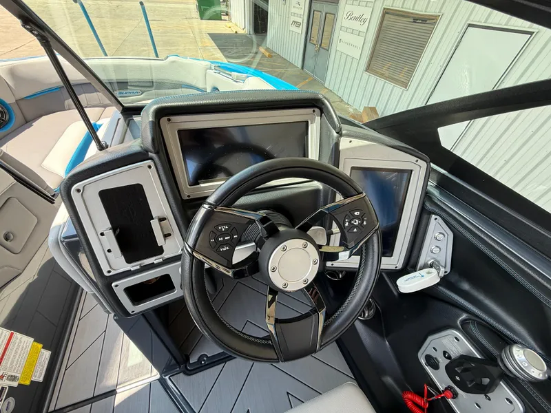 Slide: The Image of 2020 Supra SE550 boat dashboard with steering wheel and digital displays. - 11
