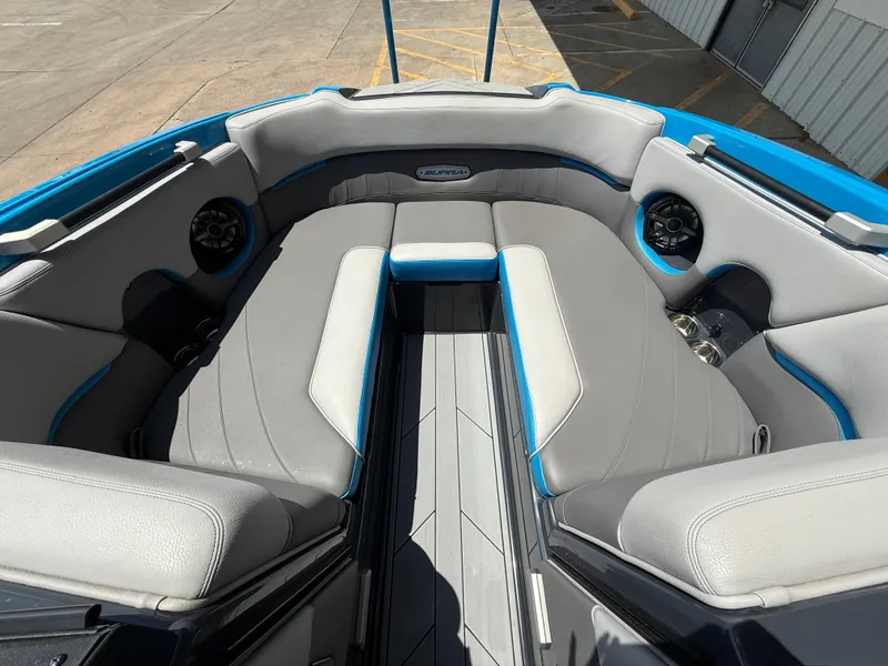 Slide: The Image of 2020 Supra SE550 boat interior with gray seating and blue accents. - 12