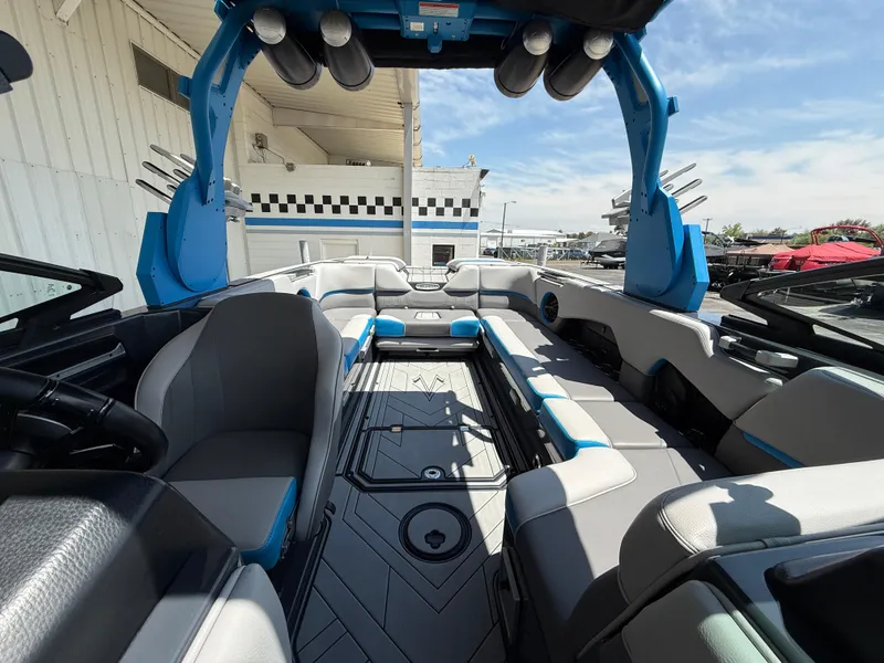 Slide: The Image of 2020 Supra SE550 boat interior with modern seating and blue accents. - 13