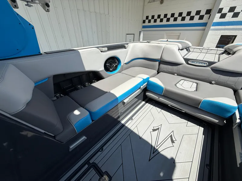 Slide: The Image of 2020 Supra SE550 boat interior with gray and blue seating, modern design, and spacious layout. - 15