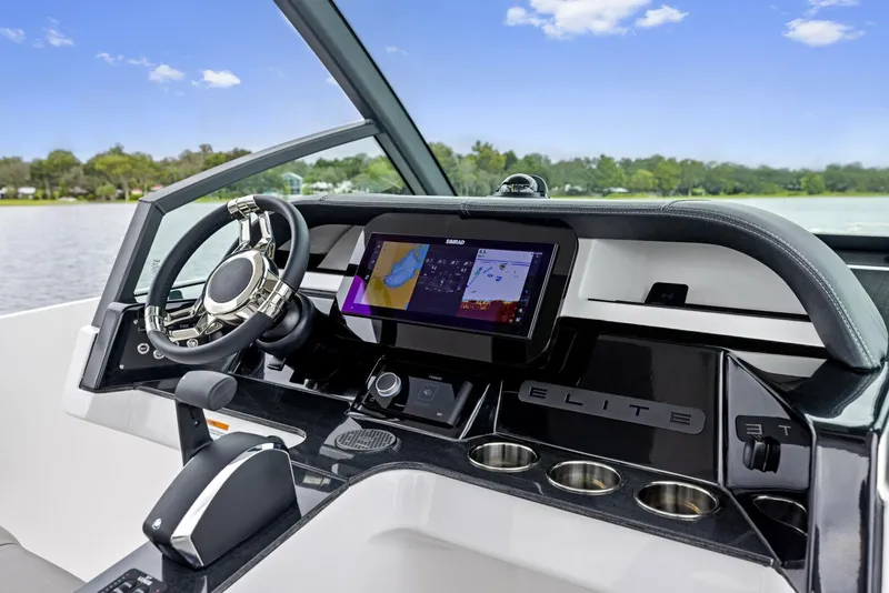 Slide: The Image of 2025 Monterey Elite 27 boat dashboard with modern steering and navigation display. - 6