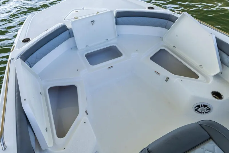 Slide: The Image of 2020 NauticStar 211 Hybrid boat on lift, docked by clear water. - 8