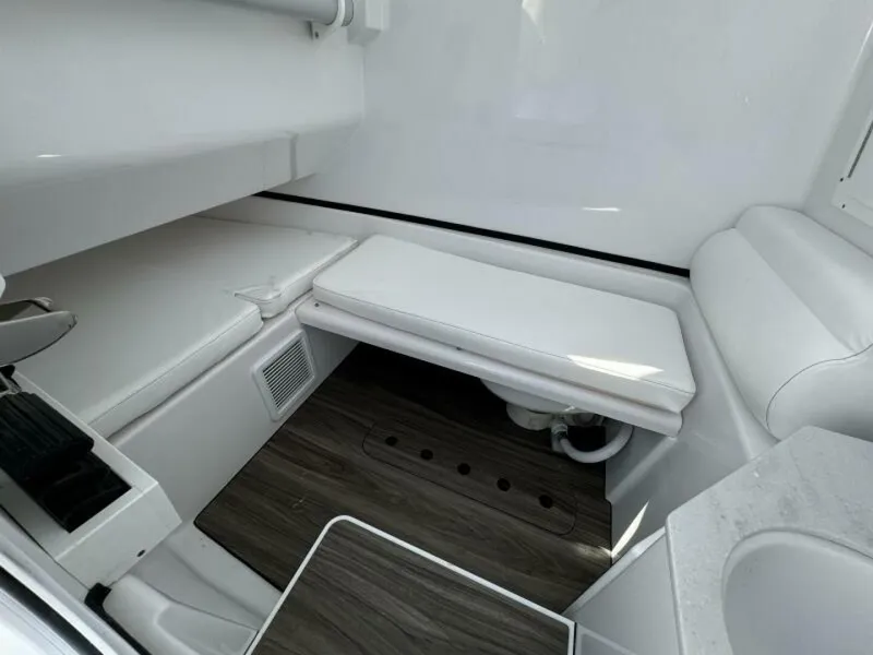 Slide: The Image of 2025 Sportsman 322 Open interior with white seating and wood flooring. - 10