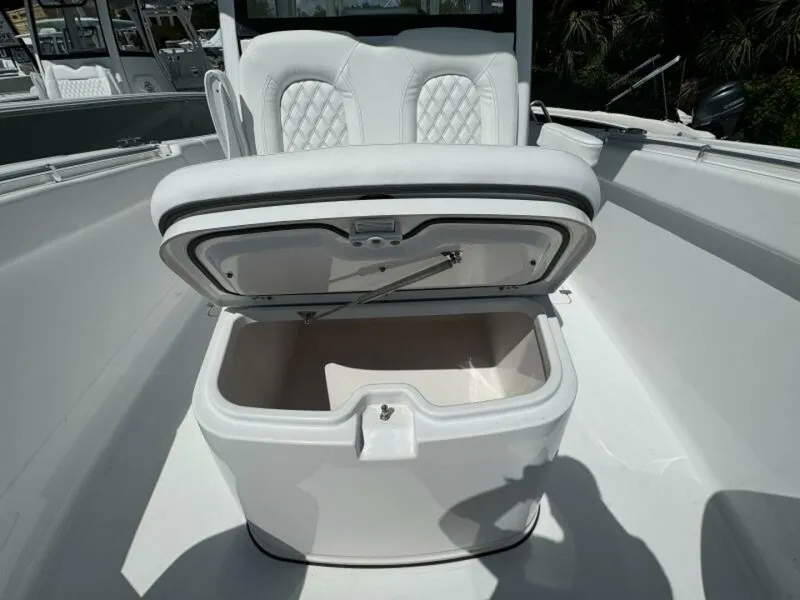 Slide: The Image of 2025 Sportsman 322 Open boat with open storage compartment and cushioned seating. - 6
