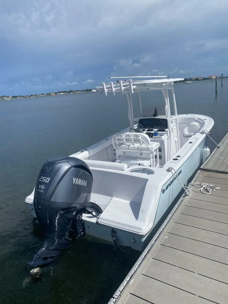 Slide: The Image of 2022 Sportsman 232 Open boat docked with Yamaha 250 V6 engine. - 2