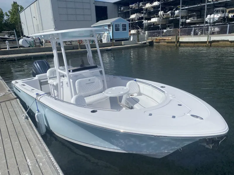 Slide: The Image of 2022 Sportsman 232 Open boat docked at marina, featuring sleek design and spacious seating. - 3