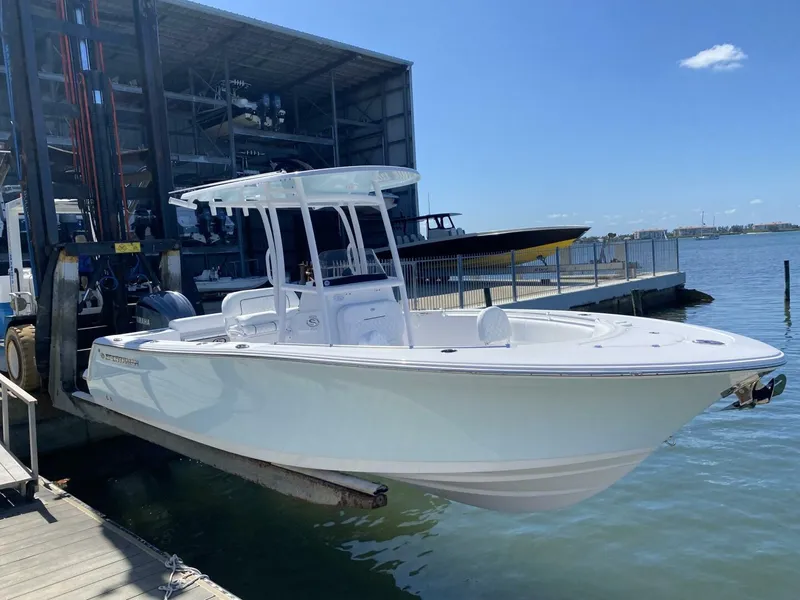 Slide: The Image of 2022 Sportsman 232 Open boat docked at marina under clear blue sky. - 4