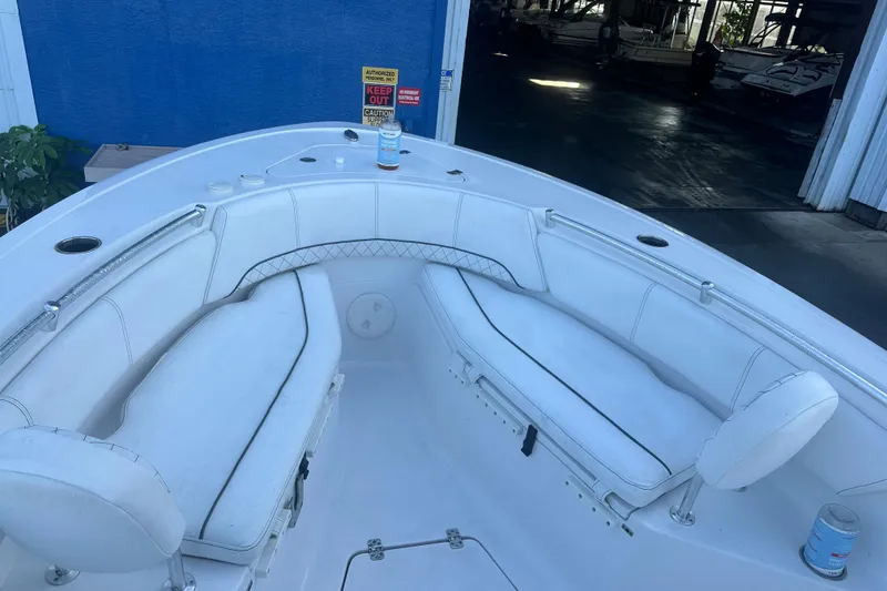 Slide: The Image of 2022 Sportsman Open 232 Center Console boat interior with white seating and cup holders. - 7