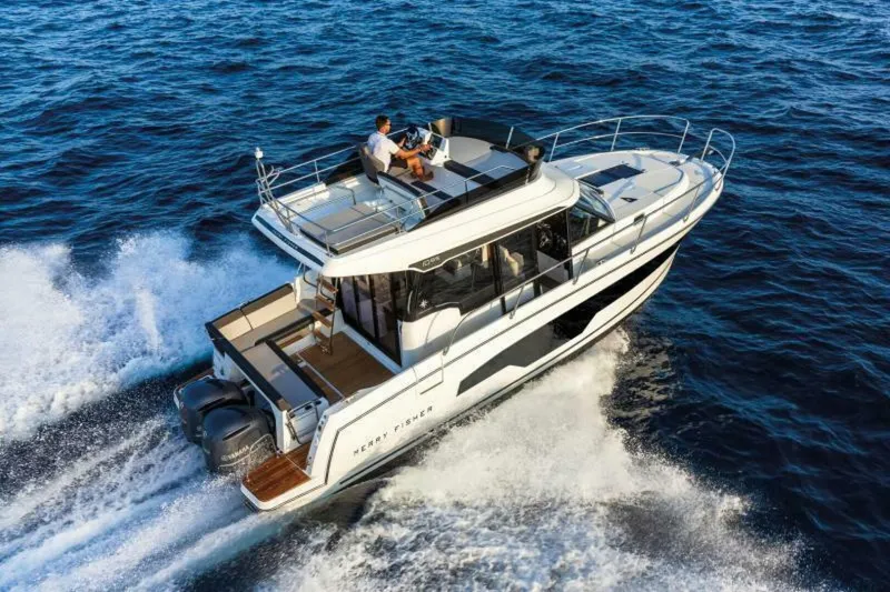 Slide: The Image of 2025 Jeanneau NC 1095 Fly cruising on open water, showcasing sleek design and powerful engines. - 1