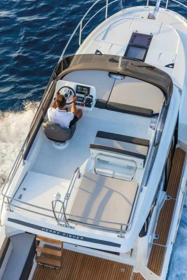 Slide: The Image of 2025 Jeanneau NC 1095 Fly cruising on open water, top view of flybridge. - 2