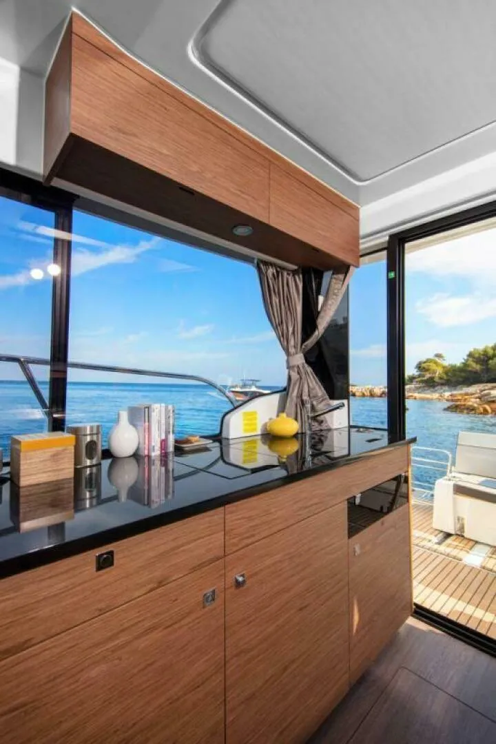 Slide: The Image of Modern kitchen interior on Jeanneau NC 1095 Fly yacht, 2025 model, with ocean view. - 8