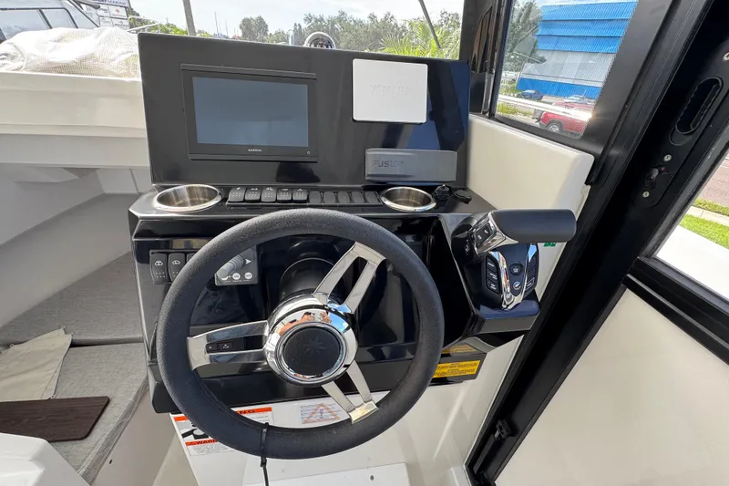 Slide: The Image of 2025 Jeanneau NC 795 SPORT S2 helm with steering wheel and control panel. - 11