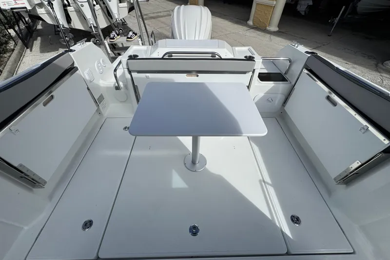 Slide: The Image of 2025 Jeanneau NC 795 SPORT S2 boat deck with table and seating. - 3