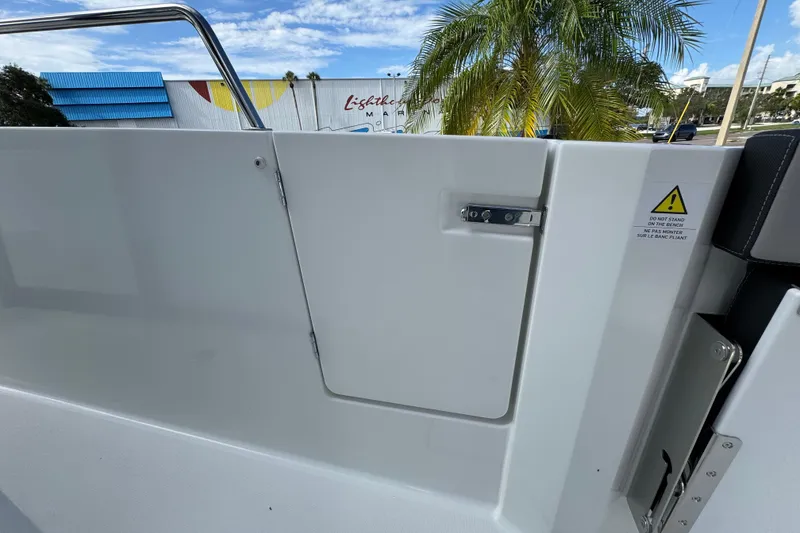 Slide: The Image of 2025 Jeanneau NC 795 SPORT S2 boat detail with safety warning and palm tree background. - 6