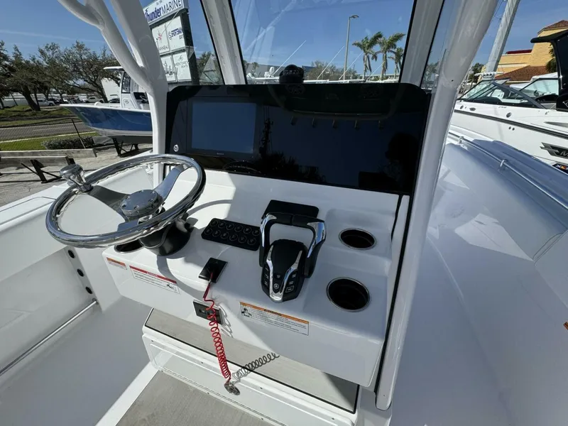 Slide: The Image of 2025 Sportsman 252 Open boat console with steering wheel and controls. - 10