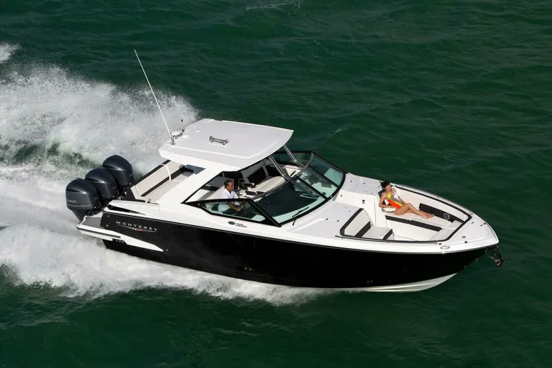 Slide: The Image of 2025 Monterey 385SS boat cruising on open water with passengers enjoying the ride. - 1
