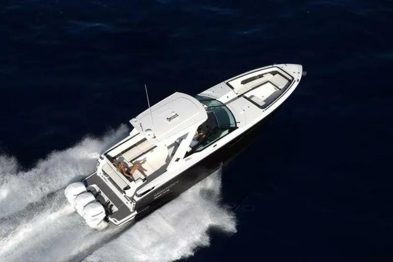 Slide: The Image of 2025 Monterey 385SS boat cruising on open water, aerial view. - 2