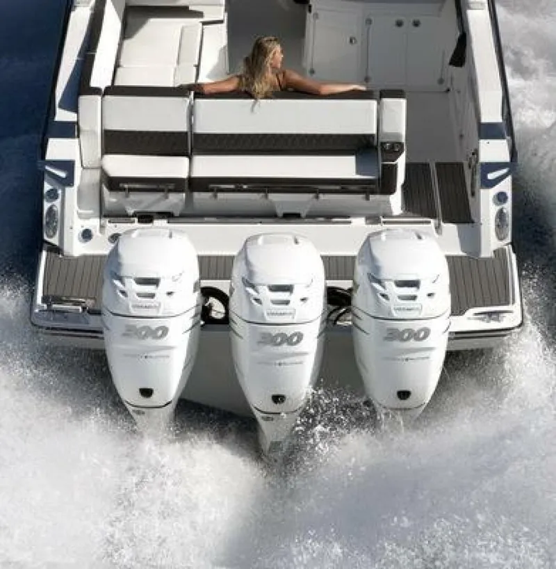 Slide: The Image of 2025 Monterey 385SS boat with triple outboard engines cruising on water. - 9