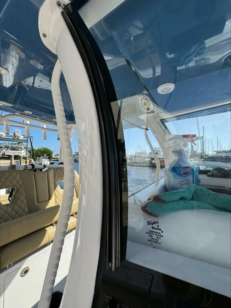 Slide: The Image of Interior of a 2023 Sportsman boat with cleaning supplies and marina view. - 11