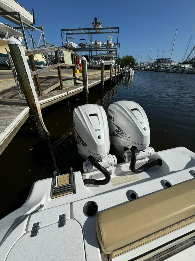 Slide: The Image of Twin Yamaha outboard motors on a Sportsman boat docked at a marina, 2023. - 12