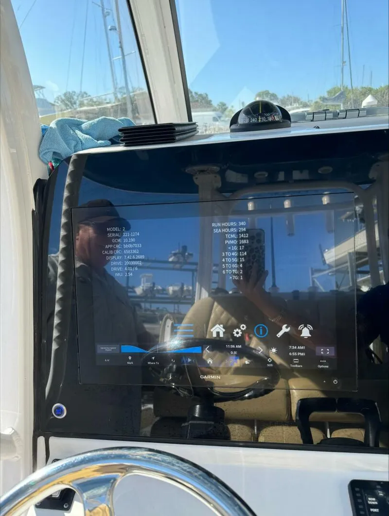 Slide: The Image of Boat dashboard with Garmin display showing engine data and settings, Sportsman 2023 model. - 14
