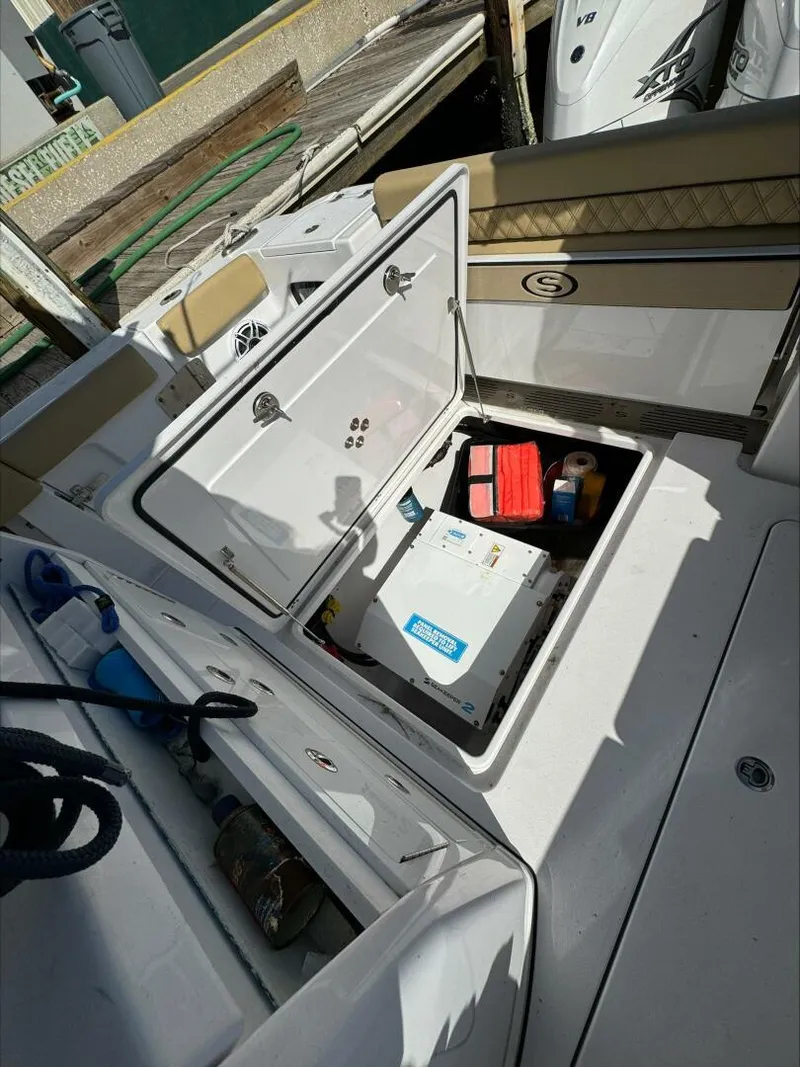 Slide: The Image of Open storage compartment on a 2023 Sportsman boat, revealing equipment and supplies. - 15