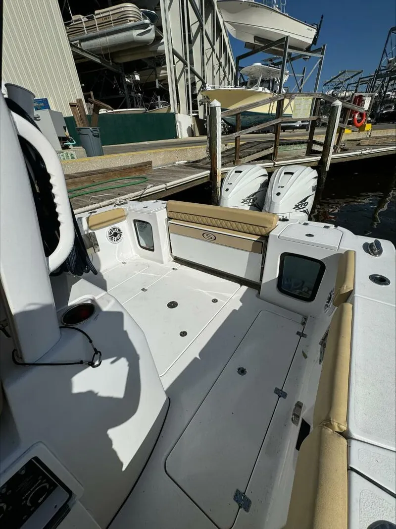 Slide: The Image of 2023 Sportsman boat interior with dual engines docked at marina. - 16