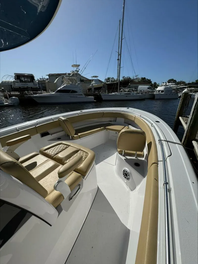 Slide: The Image of 2023 Sportsman boat with tan seating docked at a marina under clear blue sky. - 18
