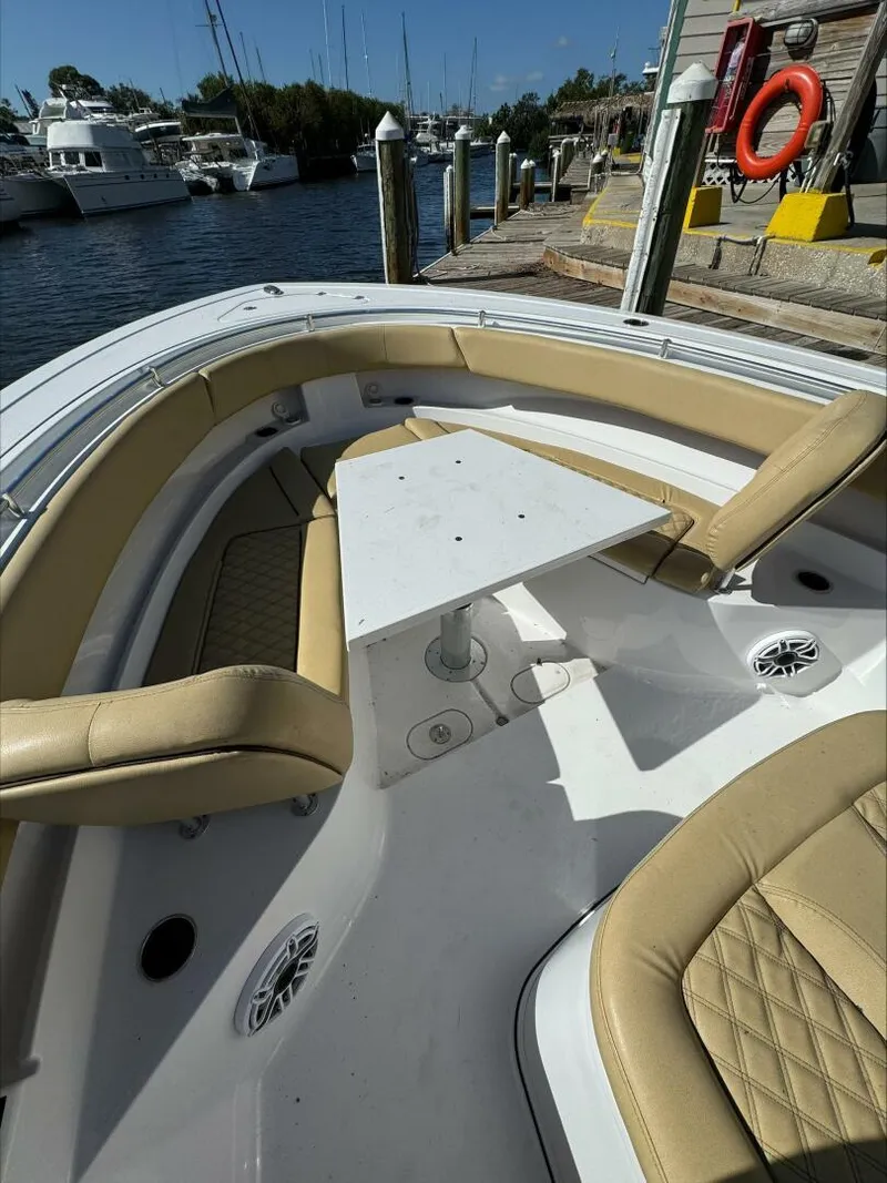 Slide: The Image of Luxury boat seating area with beige cushions and a central table, docked at a marina. - 20