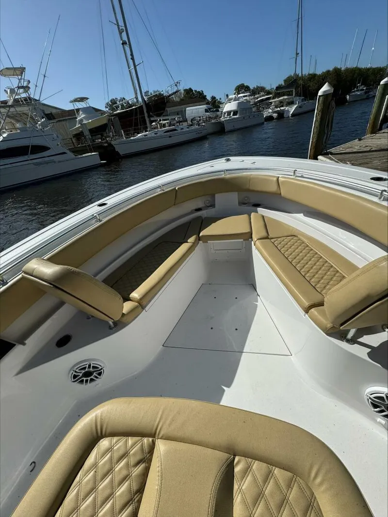 Slide: The Image of 2023 Sportsman boat interior with tan seating, docked at marina. - 21
