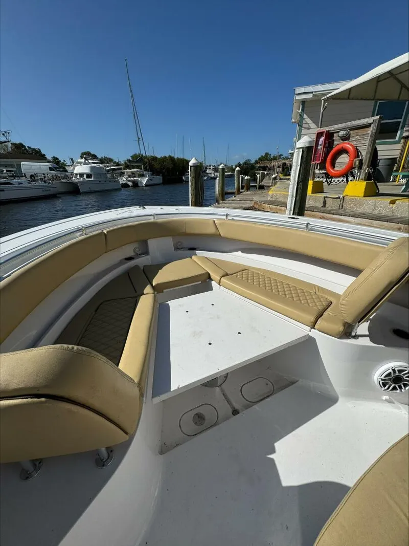 Slide: The Image of Bow seating area of a 2023 Sportsman boat docked at a marina. - 23