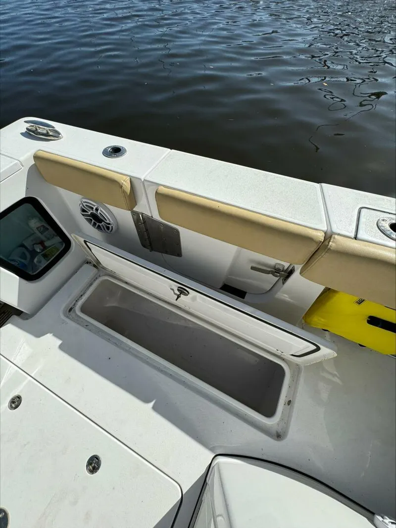 Slide: The Image of Open storage compartment on a 2023 Sportsman boat, near water. - 24