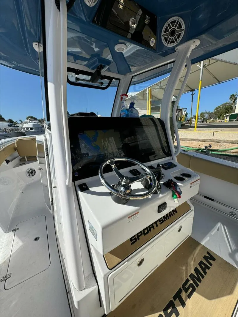Slide: The Image of 2023 Sportsman boat cockpit with steering wheel and navigation system. - 25