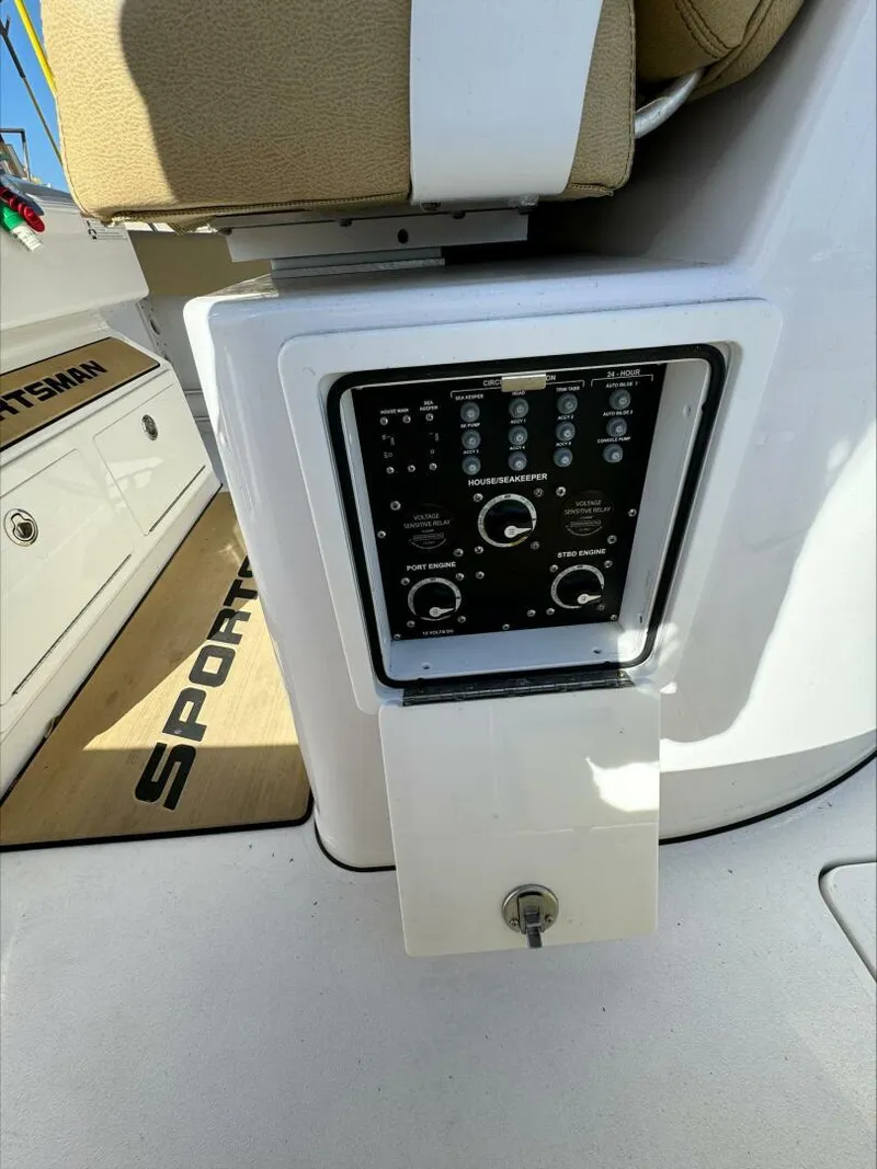 Slide: The Image of Control panel on a 2023 Sportsman boat, featuring various switches and dials. - 26