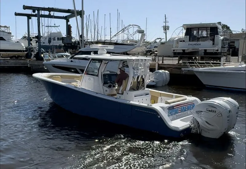 Slide: The Image of 2023 Sportsman boat with twin Yamaha engines docked at a marina. - 3