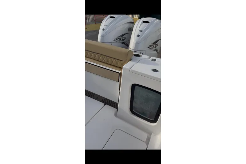 Slide: The Image of 2023 Sportsman Open 322 Center Console with Yamaha engines, rear seating view. - 30