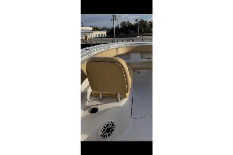 Slide: The Image of 2023 Sportsman Open 322 Center Console boat interior with tan seating and speaker. - 32