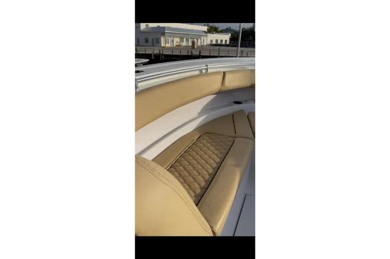 Slide: The Image of 2023 Sportsman Open 322 Center Console boat with tan cushioned seating. - 33