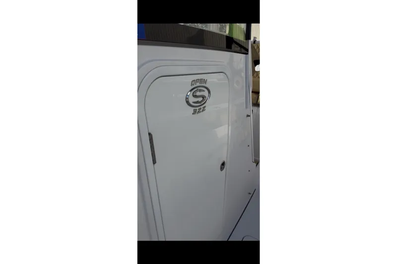 Slide: The Image of 2023 Sportsman Open 322 Center Console boat door with logo detail. - 36