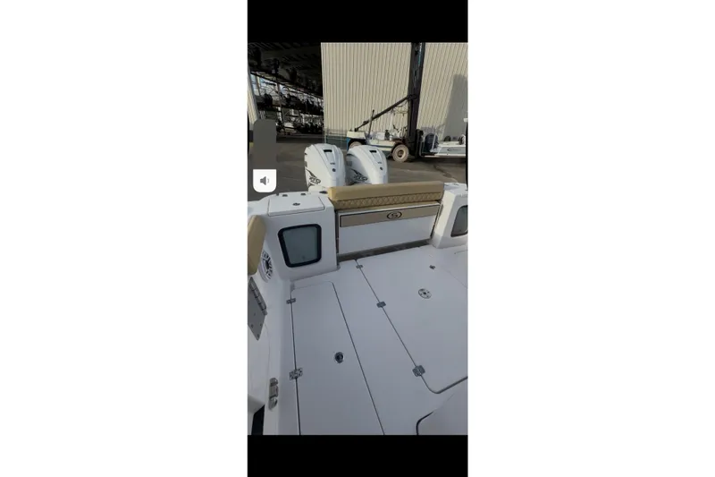 Slide: The Image of 2023 Sportsman Open 322 Center Console boat interior with dual engines and seating. - 40