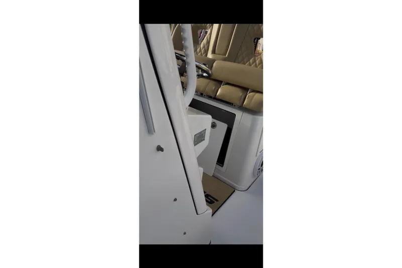 Slide: The Image of 2023 Sportsman Open 322 Center Console interior with tan seating and console details. - 53