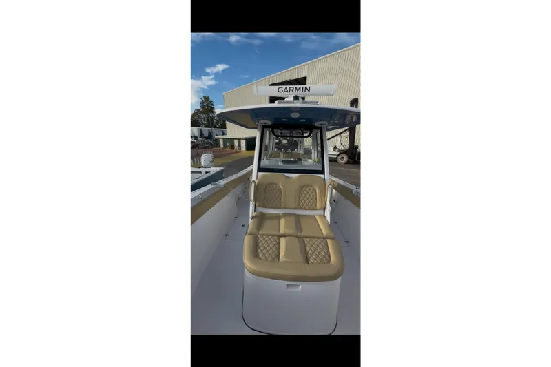 Slide: The Image of 2023 Sportsman Open 322 Center Console boat with tan seating and Garmin equipment. - 54