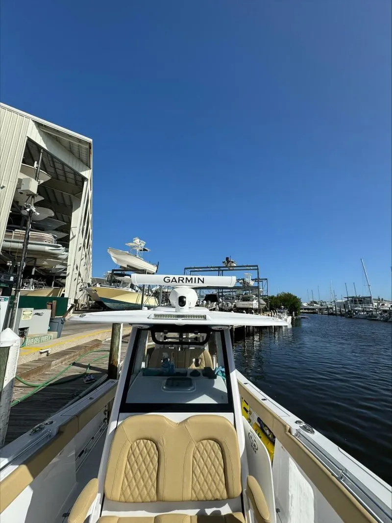 Slide: The Image of 2023 Sportsman boat docked near marina with clear blue sky. - 6