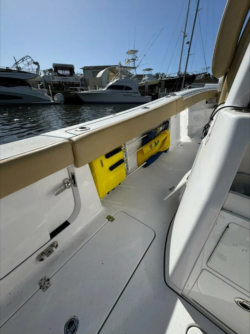 Slide: The Image of 2023 Sportsman boat interior with yellow life jackets, docked at marina. - 7