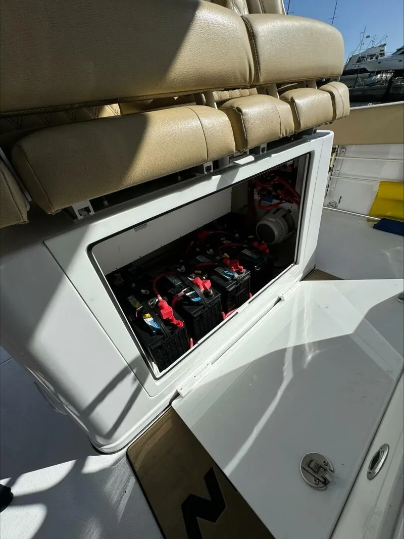 Slide: The Image of Open compartment on a 2023 Sportsman boat revealing batteries and wiring. - 9