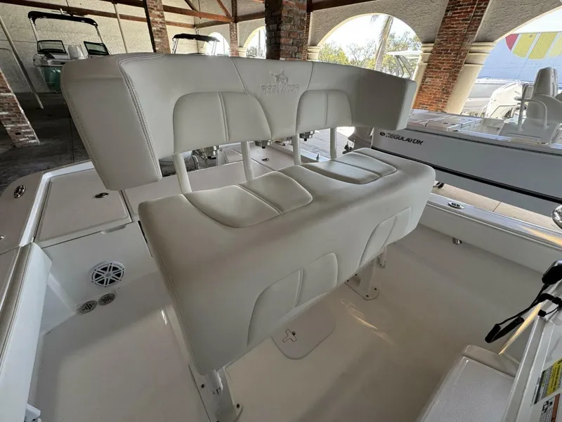 Slide: The Image of 2025 Regulator 24 XO boat interior with white cushioned seating and sleek design. - 10