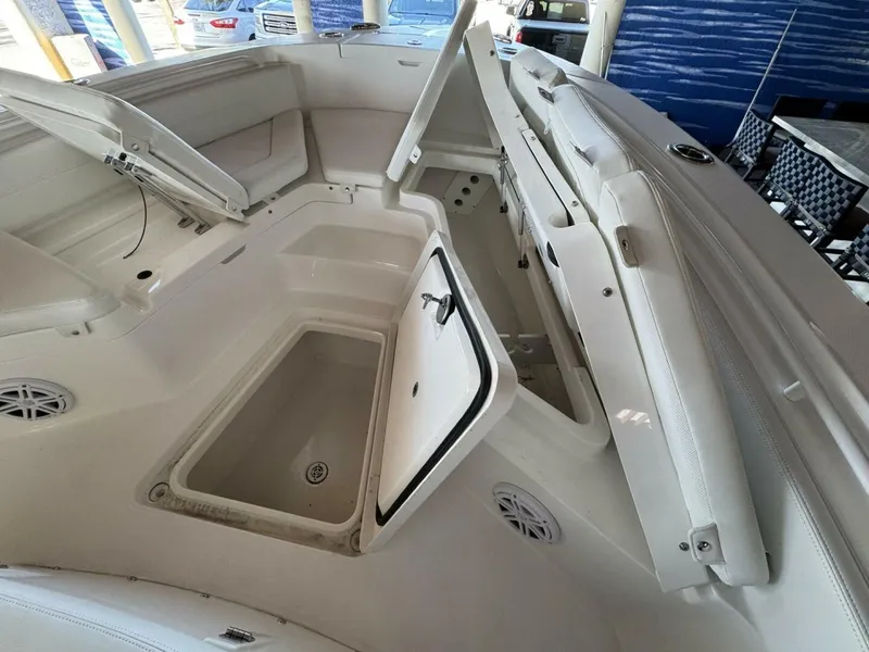 Slide: The Image of 2025 Regulator 24 XO boat interior with open storage compartments and seating. - 13