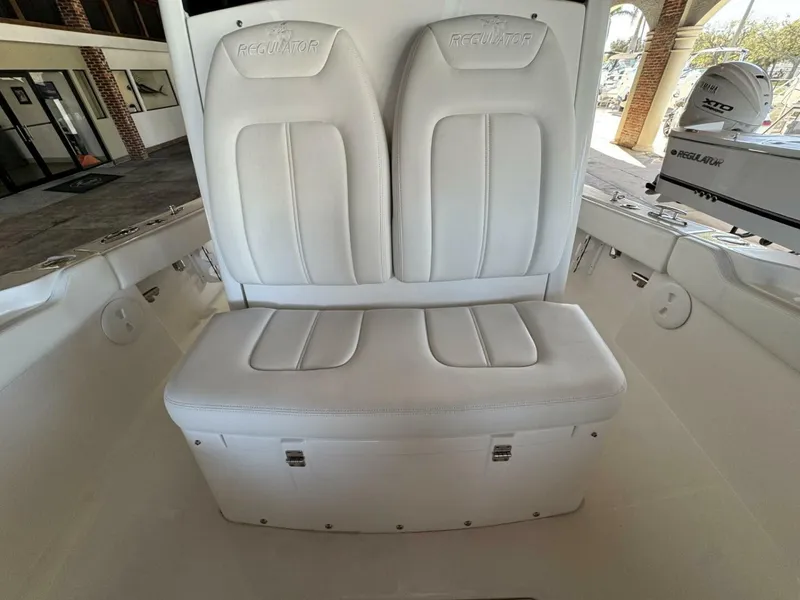 Slide: The Image of 2025 Regulator 24 XO boat interior with white cushioned seating. - 14