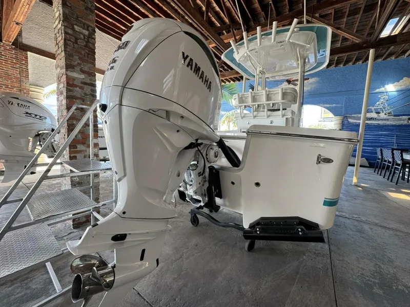 Slide: The Image of 2025 Regulator 24 XO boat with Yamaha outboard engine in a showroom. - 4